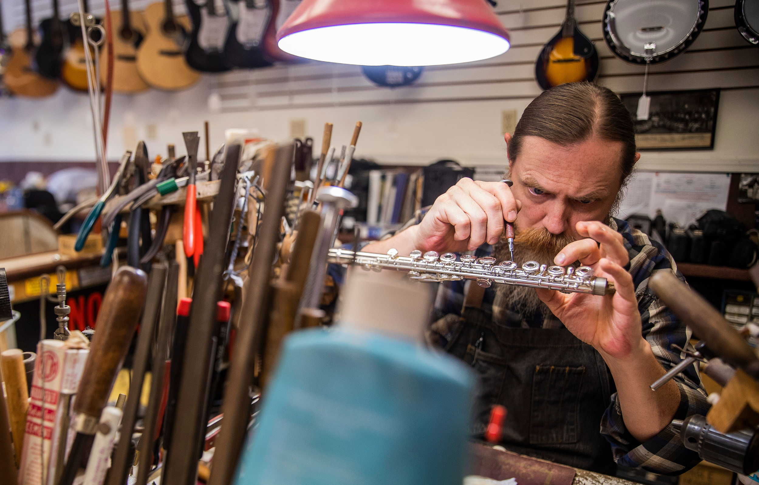 Michael Gonsor repairs a flute Wednesday, July 14, 2021, at Musicians' Repair and Sales in Indianapolis.